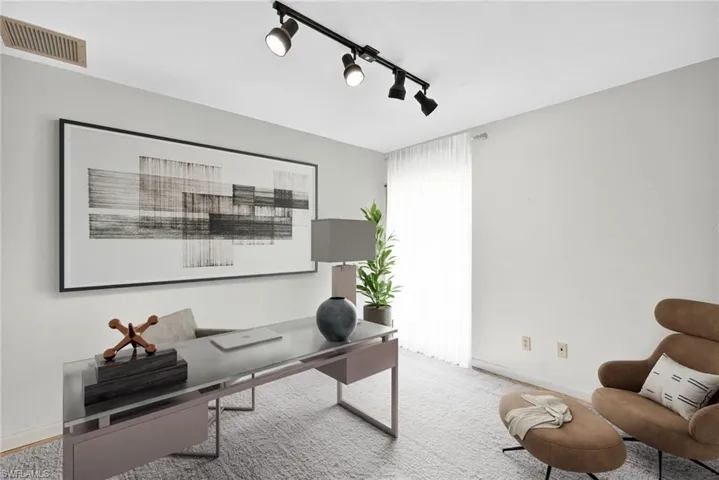 Virtually Staged Home office with track lighting and carpet
