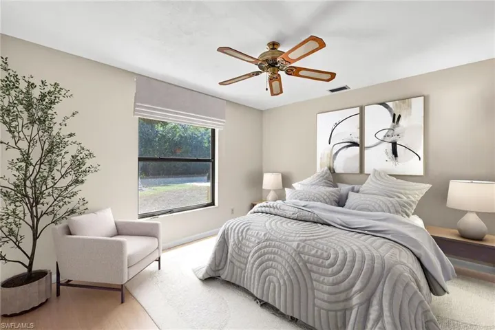 Virtually Staged Bedroom with ceiling fan and wood finished floors