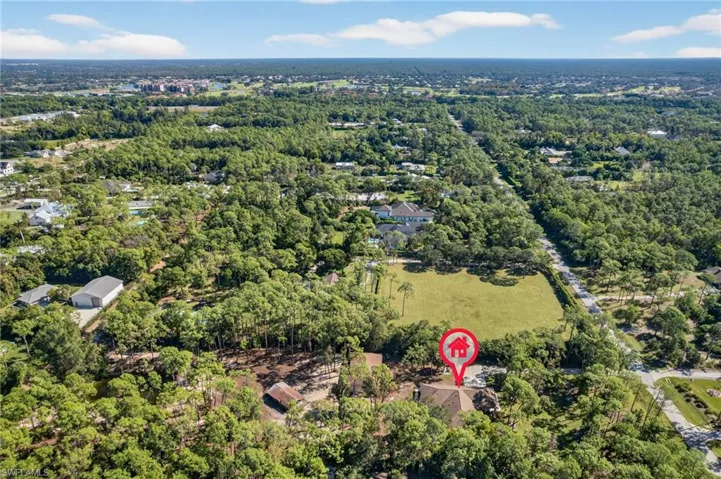 View of property location featuring a forest