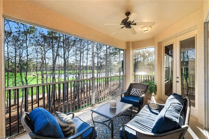 Sunroom / solarium with a ceiling fan, french doors, outdoor lounge area, and a balcony