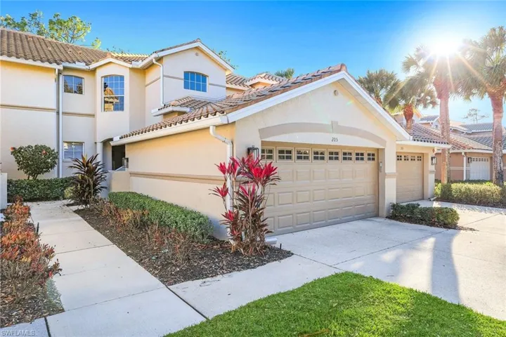 Mediterranean / spanish-style home with stucco siding, driveway, a garage, and a tiled roof