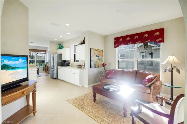 Living room featuring light tile patterned floors and recessed lighting