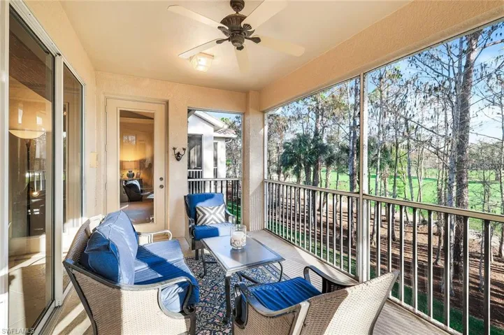 Sunroom featuring ceiling fan and a balcony