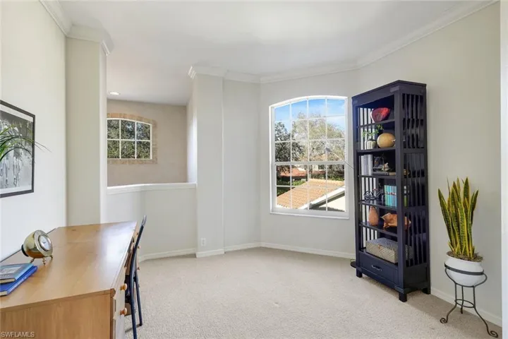 Home office featuring light colored carpet and ornamental molding