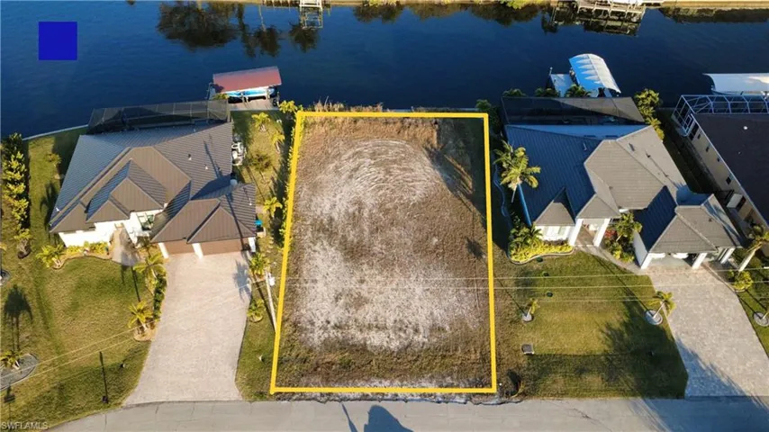 View from above of property featuring property parcel outlined and a large body of water