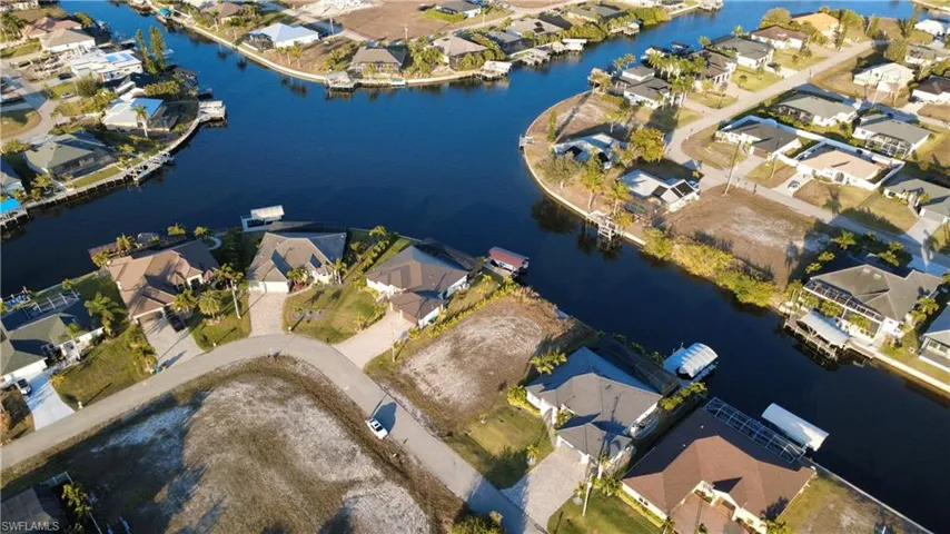 Aerial view of property's location with nearby suburban area and a large body of water