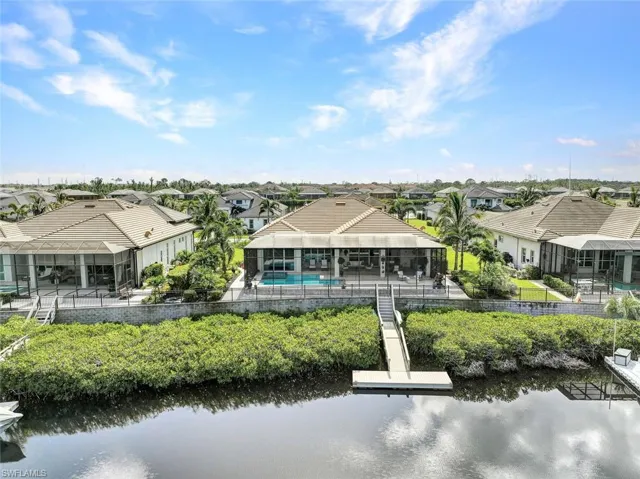 Back of property featuring a patio and a water view