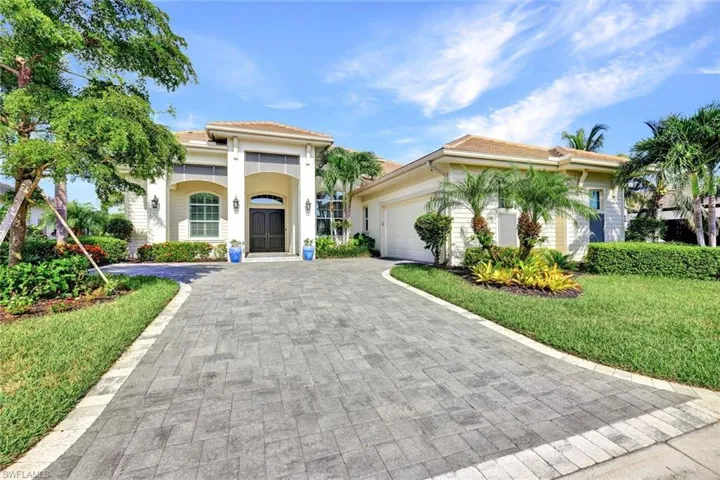 Mediterranean style house with a front yard and a garage