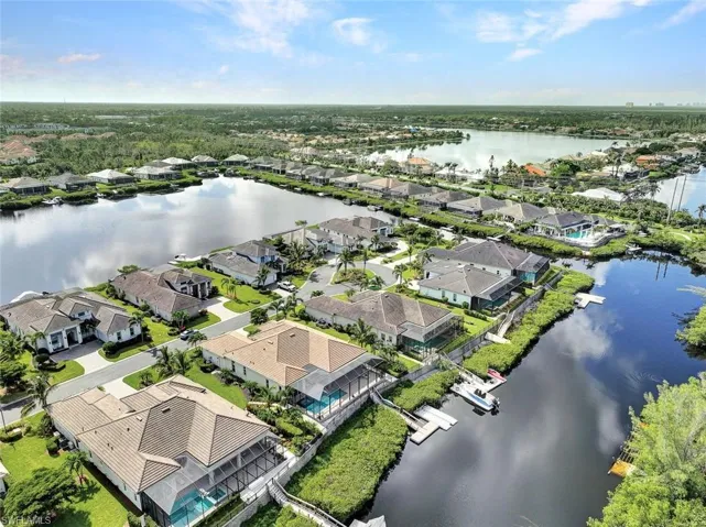 Birds eye view of property with a water view