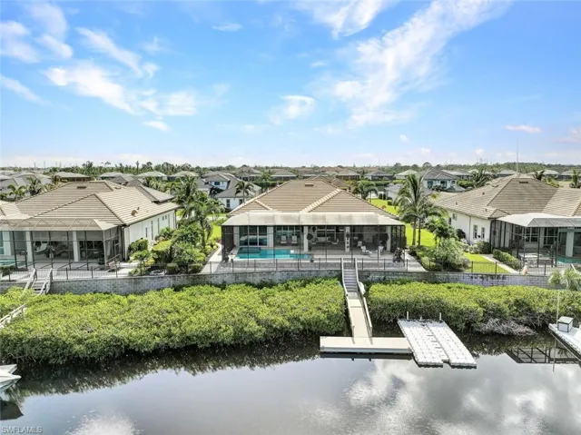 Rear view of house featuring a water view and a patio area