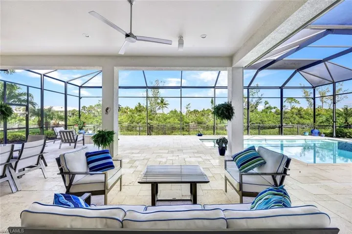 View of patio / terrace with a fenced in pool, an outdoor living space, spacious covered lanai