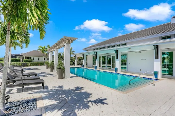 View of pool with a patio and a pergola