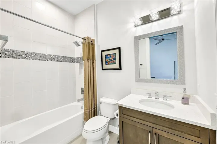 Full bathroom featuring vanity, shower / tub combo, and toilet