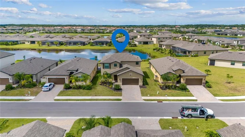 Aerial view of residential area featuring a nearby body of water