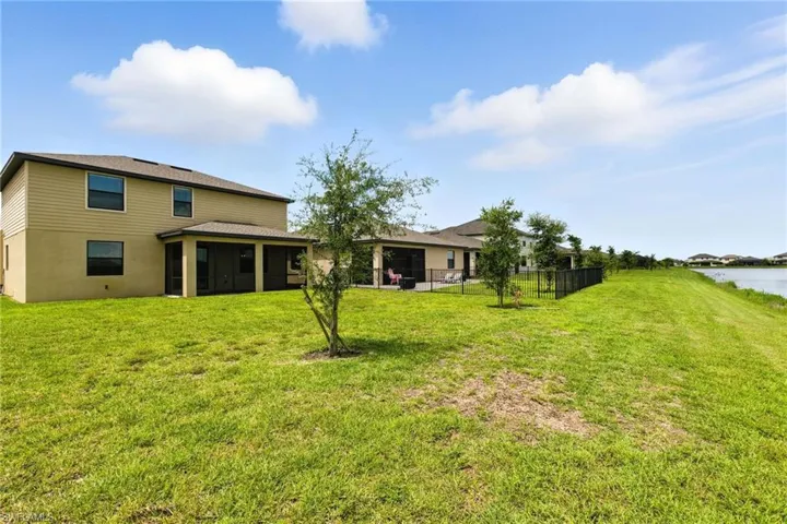 Rear view of house with a sunroom and a water view