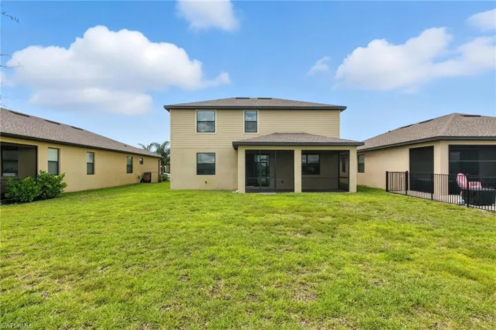 Back of property with a sunroom