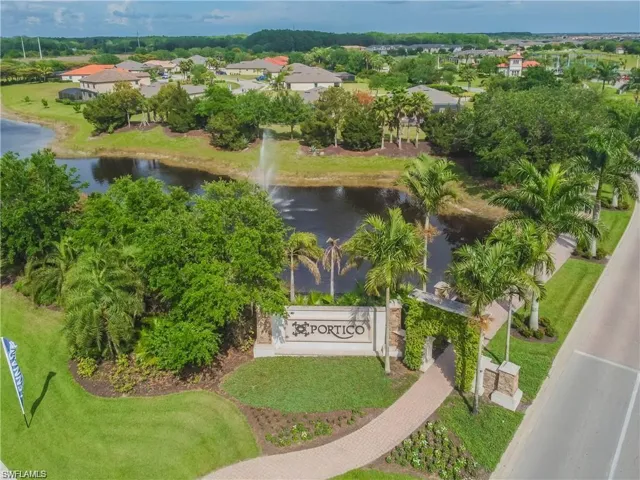 Aerial view of property and surrounding area featuring a nearby body of water