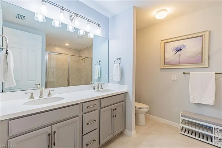 Master Bathroom featuring double vanity & walk in shower