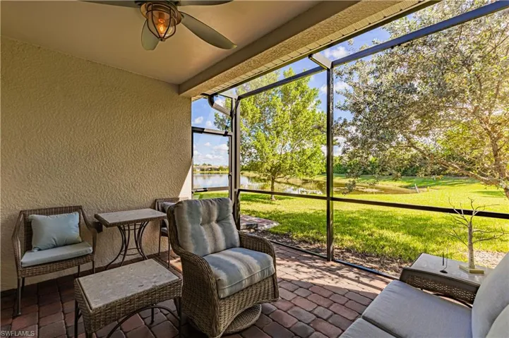 Screened in lanai with a water view and ceiling fan.