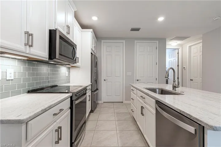 Upgraded Kitchen with teal glass listello backsplash