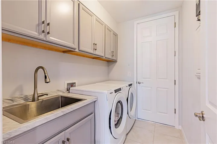 Upgraded Laundry room with lots of cabinets and storage