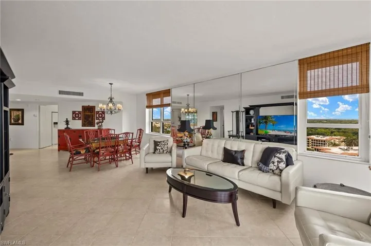 Tiled living room featuring a chandelier