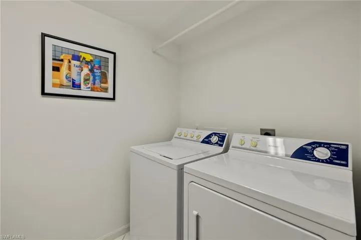 Laundry room featuring independent washer and dryer and baseboards