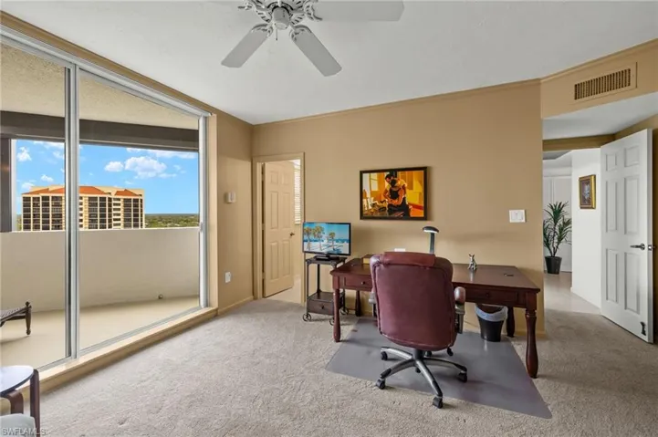 Office area featuring light colored carpet, crown molding, and ceiling fan