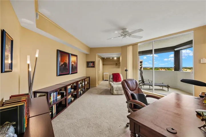 Office with ceiling fan, carpet, expansive windows, and crown molding