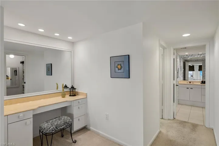 Bathroom with recessed lighting, vanity, and light tile patterned floors