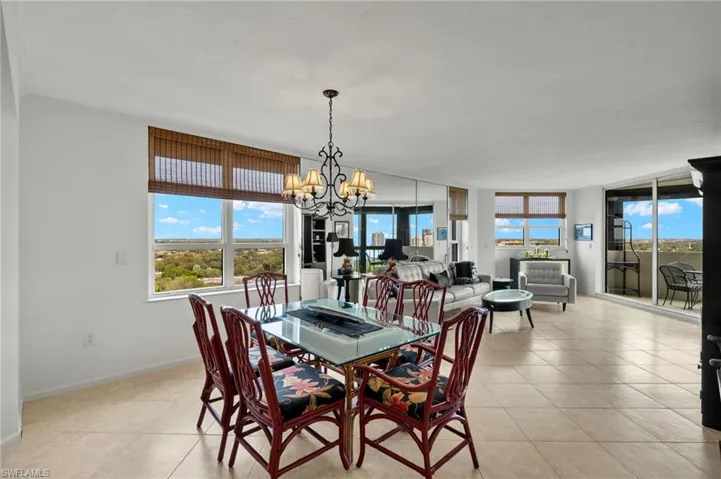 Dining room featuring light tile patterned floors and a chandelier