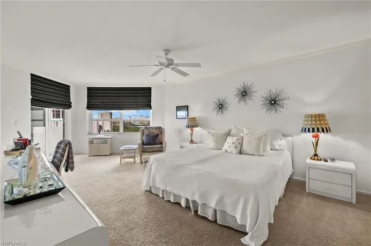 Bedroom featuring carpet, crown molding, and a ceiling fan