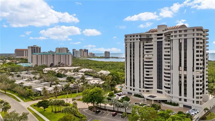 View of apartment building / complex featuring a water view and a view of city