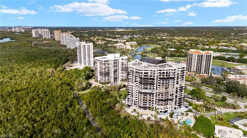 View of urban area featuring apartment complex and a large body of water