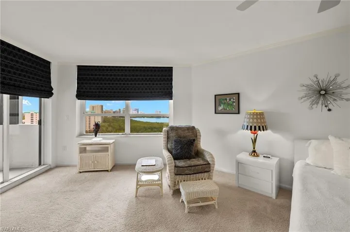 Sitting room featuring crown molding and carpet floors