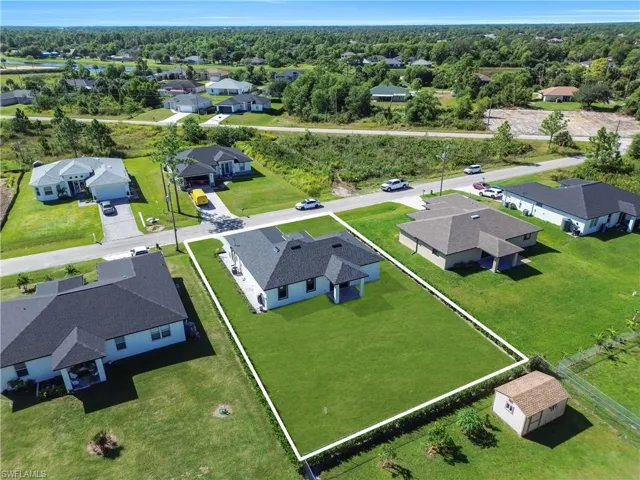 Aerial overview of property's location featuring nearby suburban area