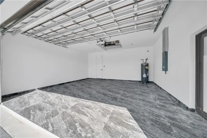 Garage with electric water heater and electric panel