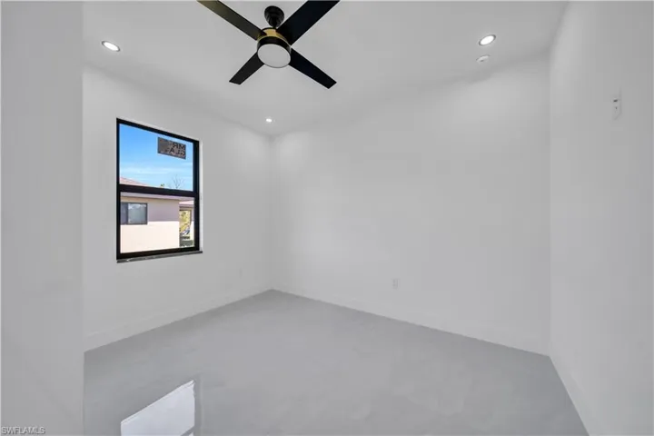 Empty room with recessed lighting and a ceiling fan