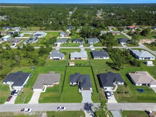 Aerial view of property's location with nearby suburban area