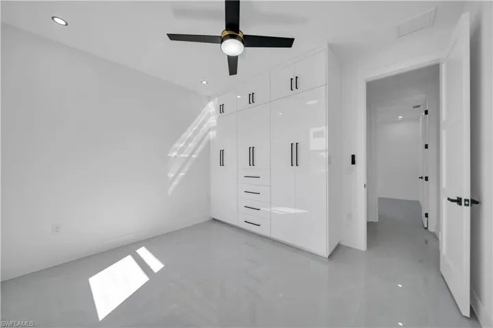 Unfurnished bedroom with a closet, recessed lighting, and a ceiling fan