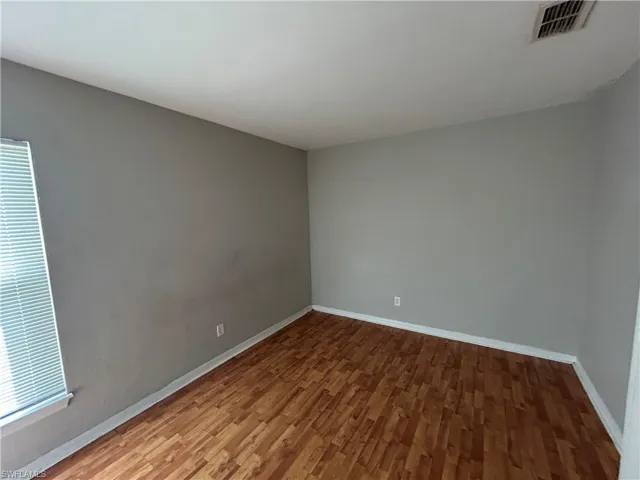 Spare room with wood finished floors and baseboards