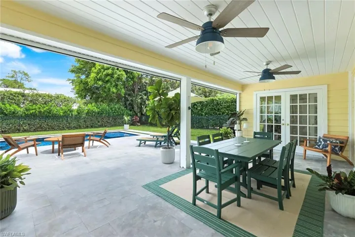 Covered lanai overlooking pool and fenced yard