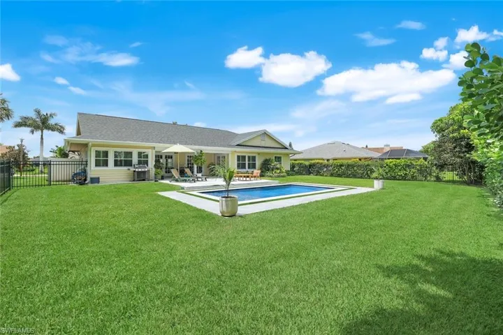 Big back yard enclosed by a new five-foot-high aluminum fence with dual-swinging, self-lock gates