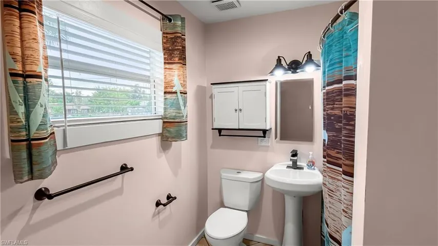 Bathroom featuring shower and tub with a window