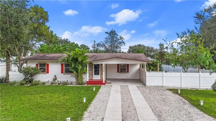 Ranch-style house with a porch and a front lawn
