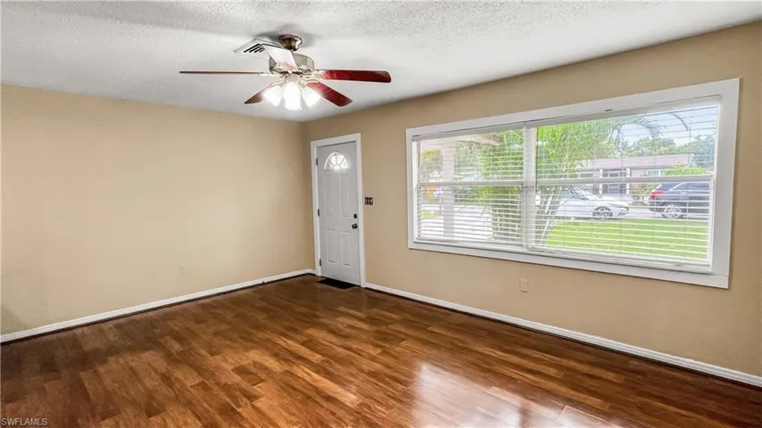 Living Room featuring ceiling fan, plenty natural light, from large window hardwood / wood-style flooring