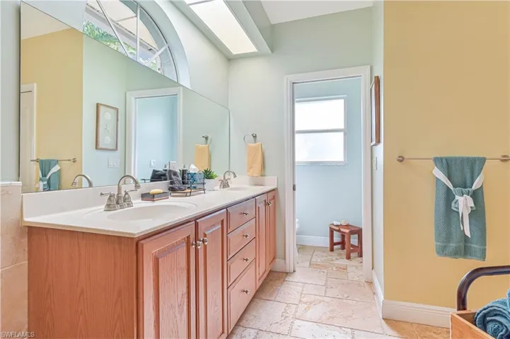 Bathroom featuring double vanity and stone tile floors