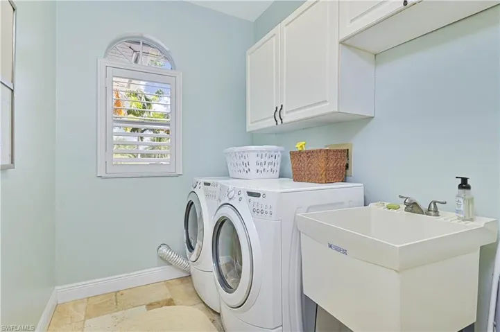 Laundry area featuring cabinet space and separate washer and dryer