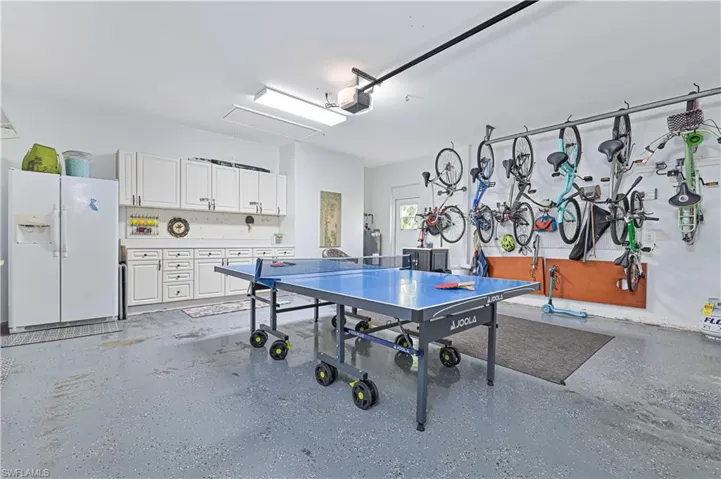 Playroom with a garage and dark aggregate flooring