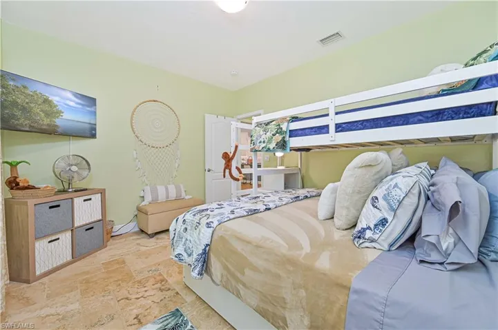 Bedroom featuring stone tile flooring